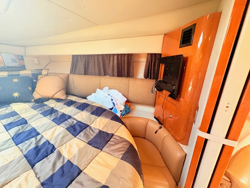 Slide: The Image of The cabin of a 2007 Chaparral Signature 350 features a cozy bed and a television. - 13