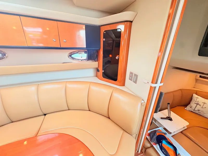Slide: The Image of The 2007 Chaparral Signature 350 interior features an elegant beige leather seating area and wooden cabinetry. - 18