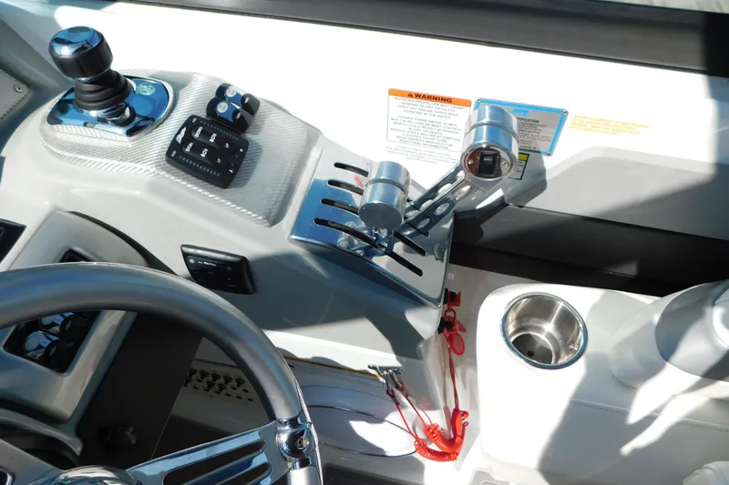 Slide: The Image of Control panel of a 2012 Formula 350 Sun Sport boat with steering wheel and throttle levers. - 32
