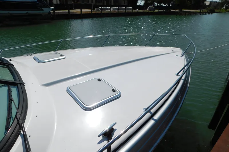 Slide: The Image of 2012 Formula 350 Sun Sport boat deck with hatches, docked on calm water. - 95
