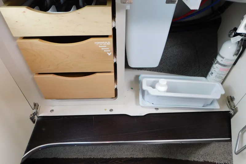 Slide: The Image of Cabinet interior of 2012 Formula 350 Sun Sport with wooden drawers and fire extinguisher. - 61