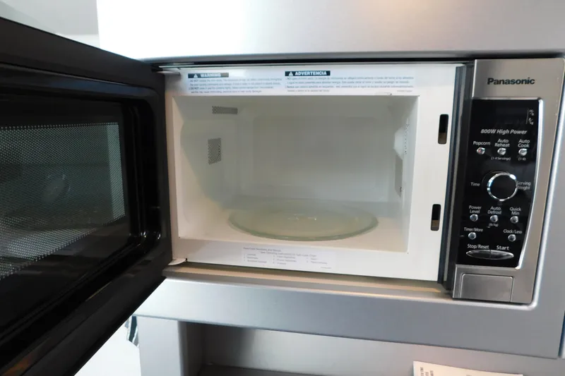Slide: The Image of Open Panasonic microwave with control panel and glass turntable visible. - 56