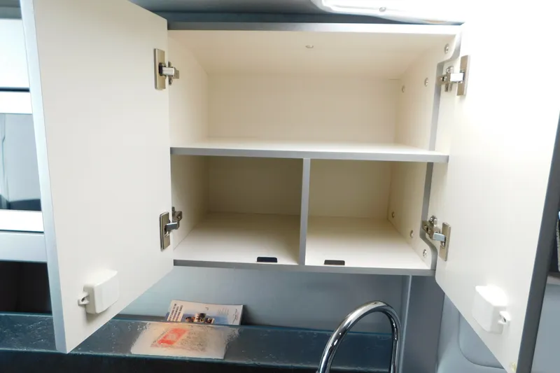 Slide: The Image of Open white cabinet with shelves above a sink in a 2012 Formula 350 Sun Sport. - 57