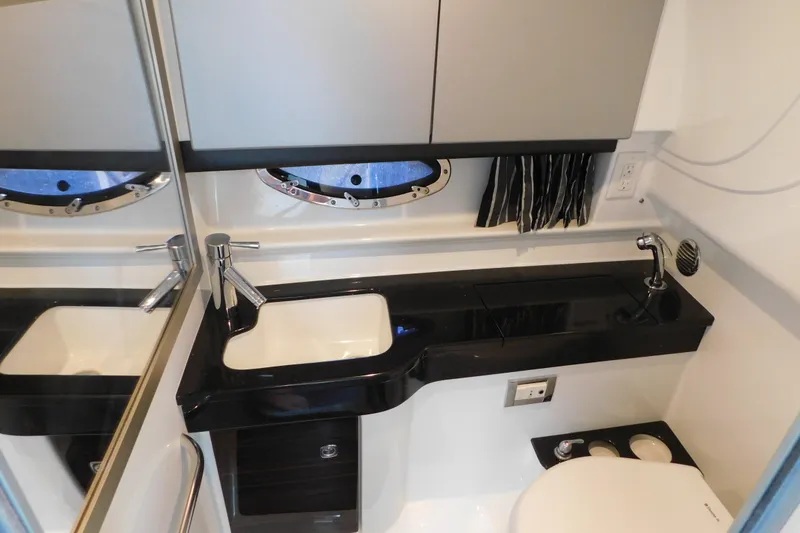 Slide: The Image of 2012 Formula 350 Sun Sport yacht bathroom with sleek black countertop and modern fixtures. - 72