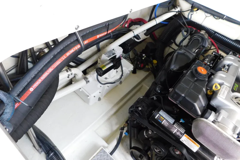 Slide: The Image of Engine compartment of a 2012 Formula 350 Sun Sport boat, showcasing hoses and components. - 78