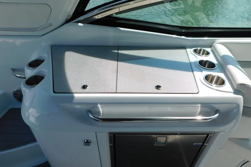 Slide: The Image of 2012 Formula 350 Sun Sport boat interior with cup holders and storage compartment. - 27