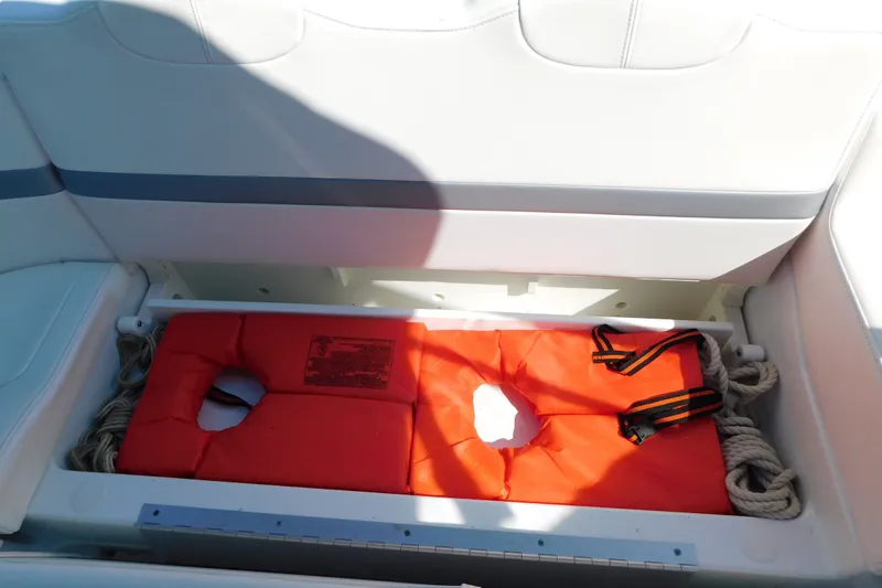 Slide: The Image of Storage compartment in a 2012 Formula 350 Sun Sport boat with life jackets and ropes. - 17