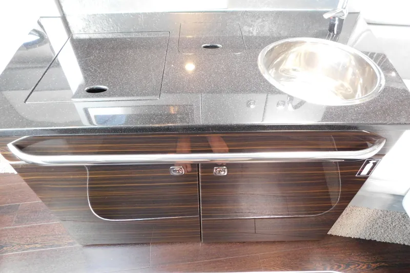 Slide: The Image of 2012 Formula 350 Sun Sport boat kitchenette with sleek countertop and stainless steel sink. - 58
