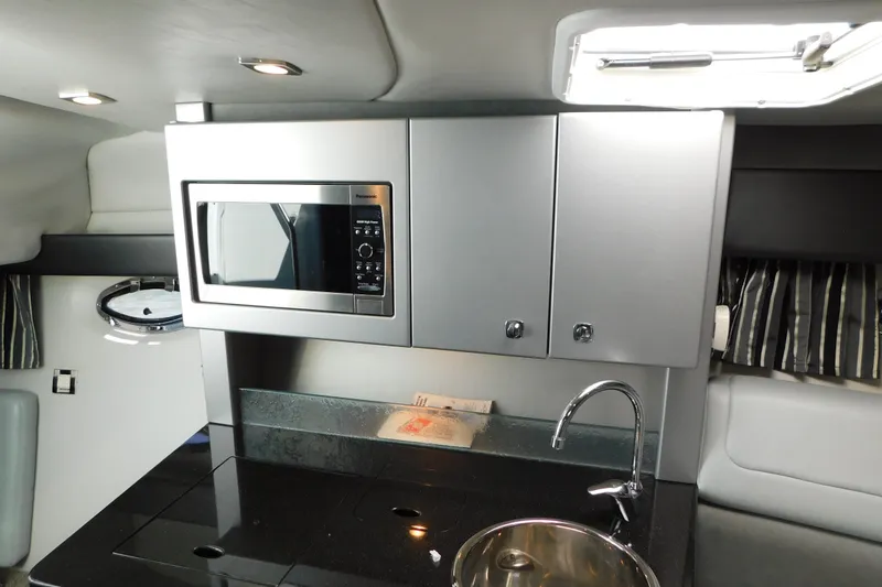 Slide: The Image of Modern kitchenette in 2012 Formula 350 Sun Sport boat with microwave and sink. - 55