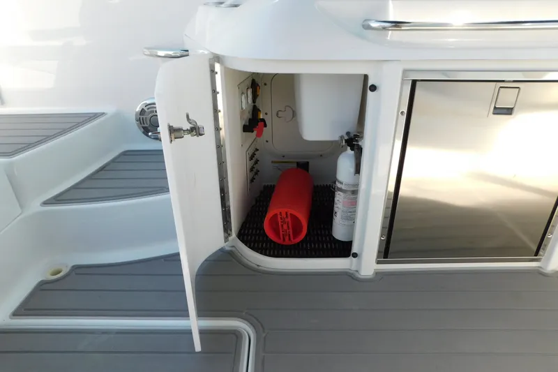 Slide: The Image of Open storage compartment on 2012 Formula 350 Sun Sport boat, featuring safety equipment. - 23