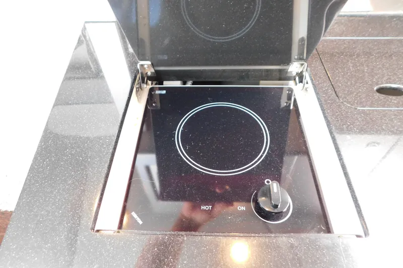 Slide: The Image of Built-in stovetop on 2012 Formula 350 Sun Sport boat, featuring a sleek black design. - 59