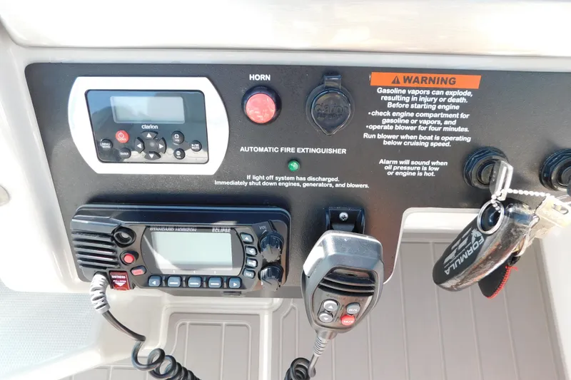 Slide: The Image of Control panel of a 2012 Formula 350 Sun Sport boat with warning labels and communication devices. - 40