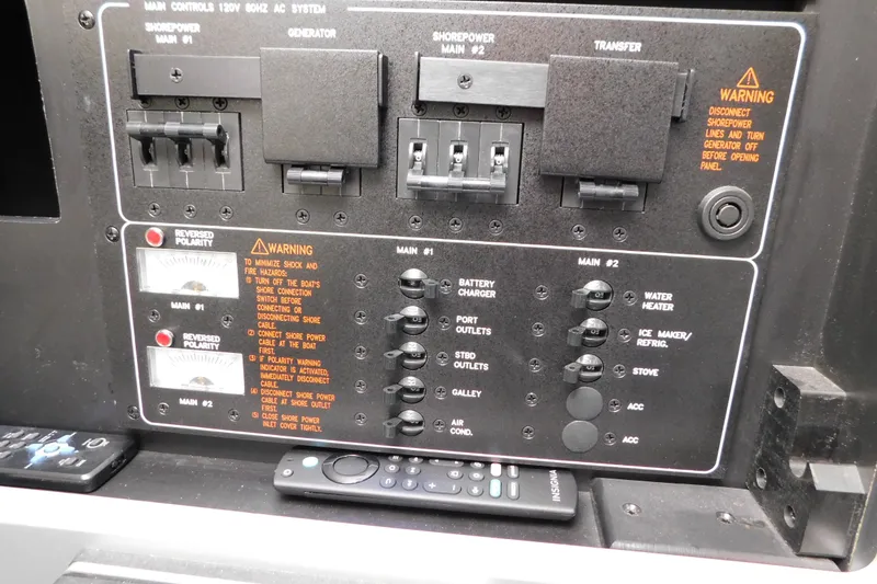 Slide: The Image of Control panel of a 2012 Formula 350 Sun Sport boat with warning labels and switches. - 52