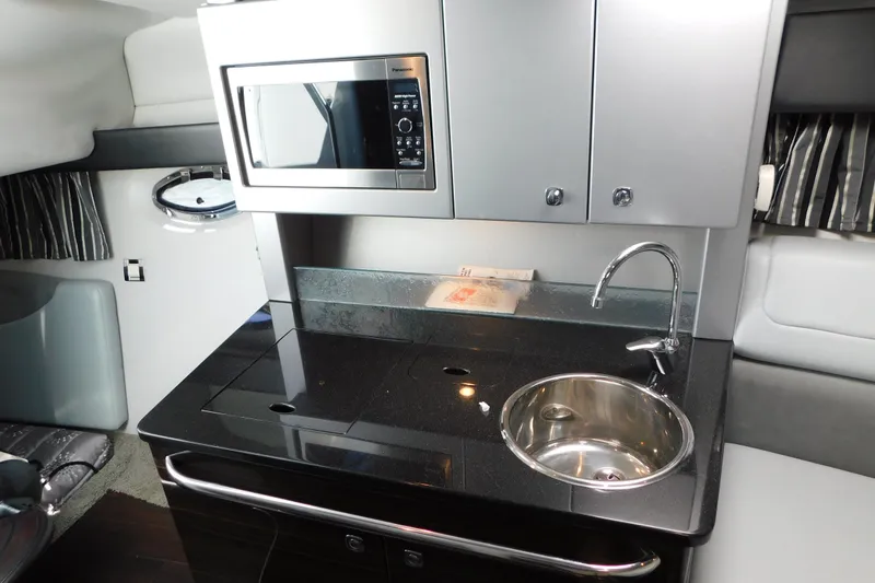 Slide: The Image of Compact kitchenette in 2012 Formula 350 Sun Sport boat with microwave and sink. - 54