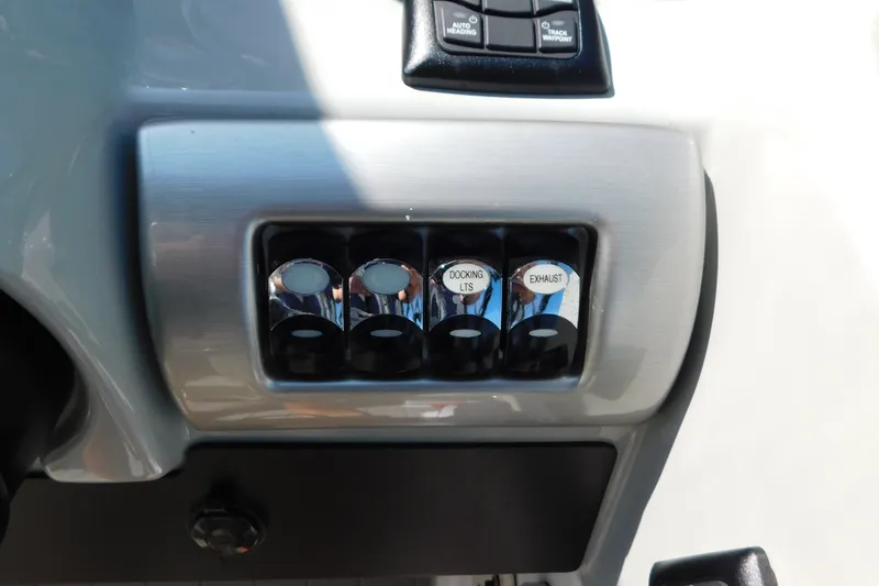 Slide: The Image of Control panel of a 2012 Formula 350 Sun Sport boat with labeled switches. - 76