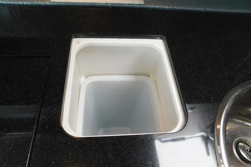 Slide: The Image of Built-in cooler on 2012 Formula 350 Sun Sport boat with black countertop. - 60