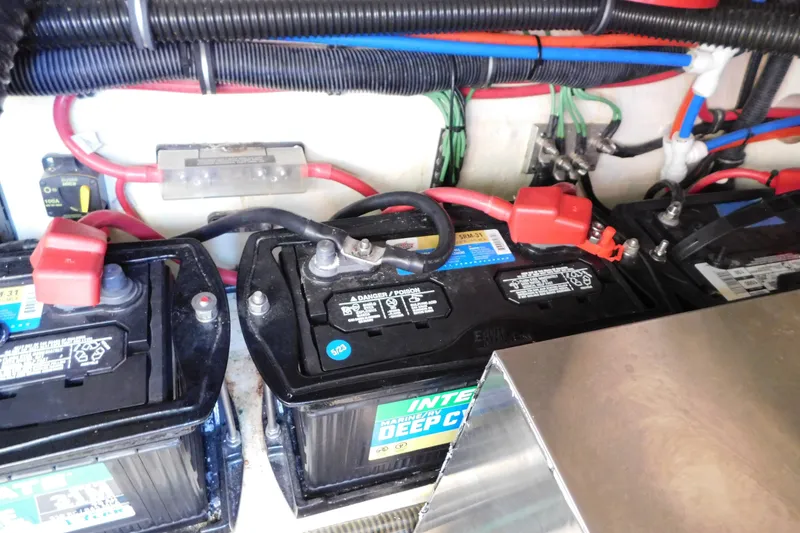 Slide: The Image of Battery compartment of a 2012 Formula 350 Sun Sport boat, featuring multiple deep cycle batteries. - 82