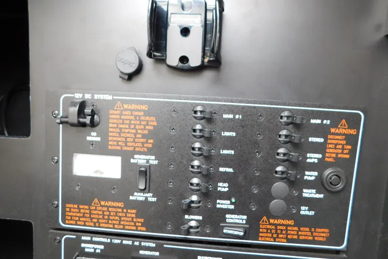 Slide: The Image of Control panel of a 2012 Formula 350 Sun Sport boat with warning labels and switches. - 51