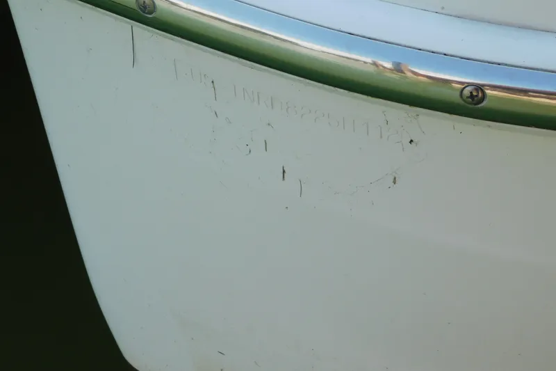 Slide: The Image of Close-up of 2012 Formula 350 Sun Sport boat hull with visible scratches and metal trim. - 99