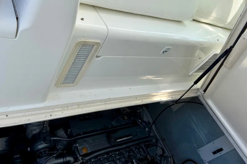 Slide: The Image of 2001 Henriques 35 Express boat engine compartment with seating and ventilation details. - 26