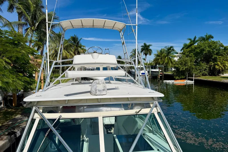 Slide: The Image of 2001 Henriques 35 Express boat docked in a tropical canal setting. - 15
