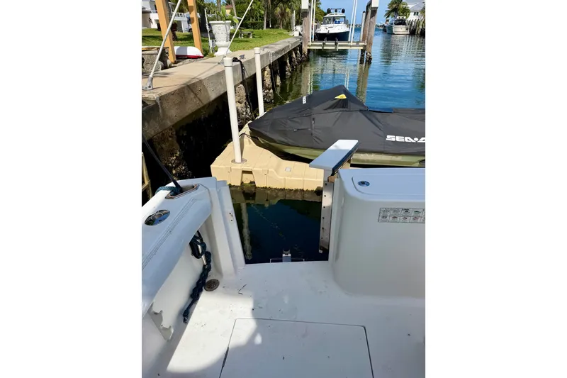 Slide: The Image of 2001 Henriques 35 Express boat docked near a jet ski in a marina. - 23