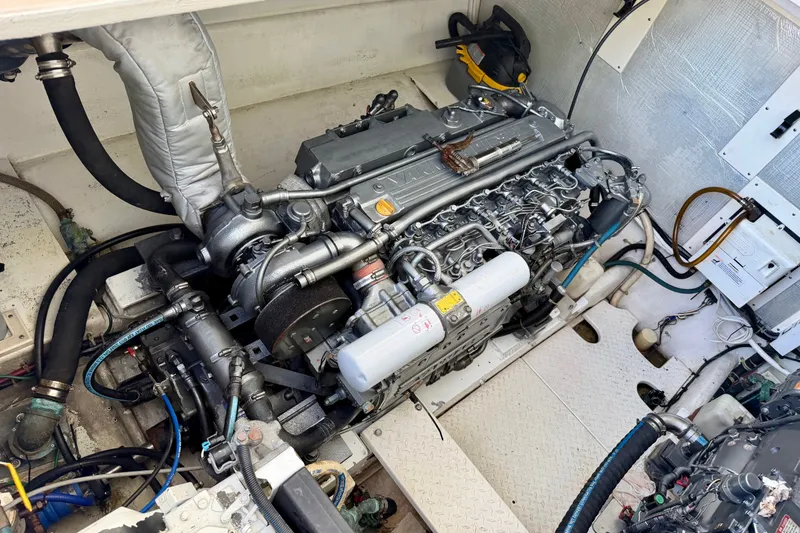 Slide: The Image of Engine compartment of a 2001 Henriques 35 Express boat, showcasing detailed machinery. - 25