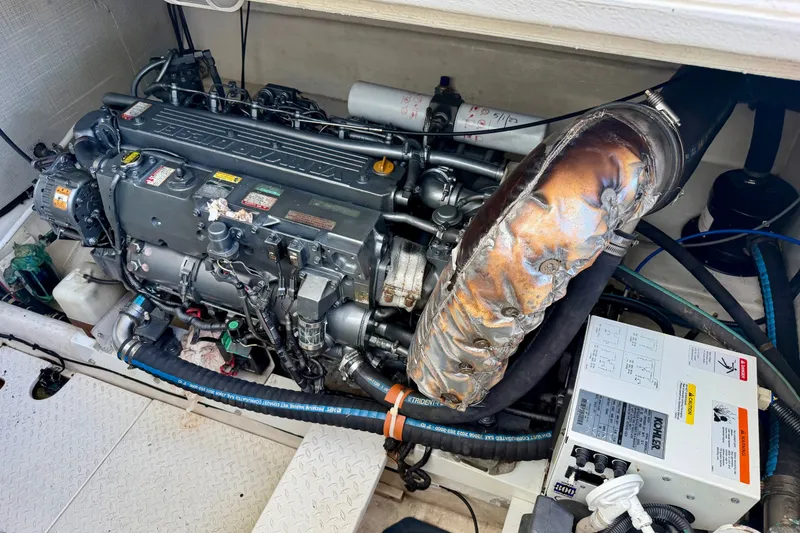 Slide: The Image of Engine compartment of a 2001 Henriques 35 Express boat, showcasing detailed machinery. - 24