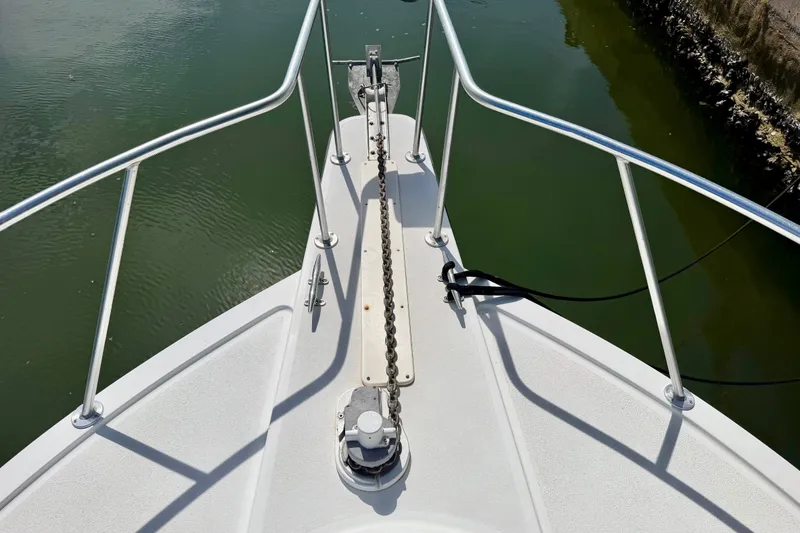 Slide: The Image of Bow view of 2001 Henriques 35 Express boat with anchor chain and railing. - 16