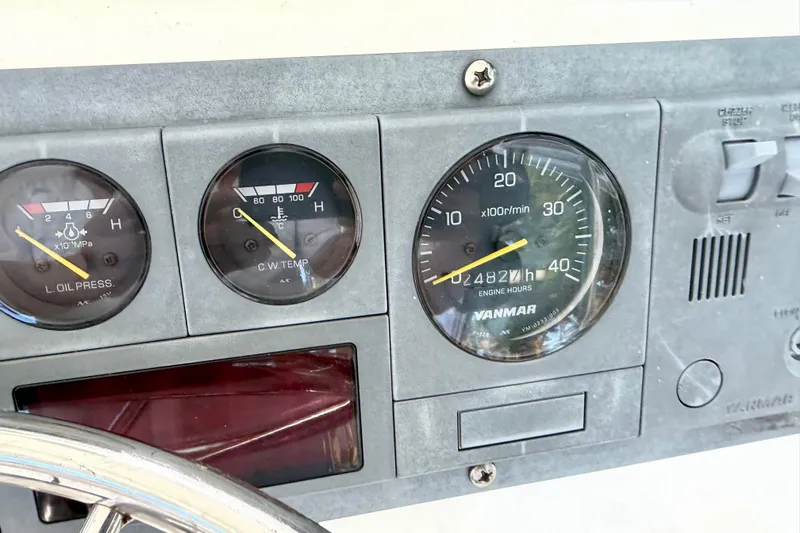 Slide: The Image of Dashboard gauges of a 2001 Henriques 35 Express boat, showing oil pressure and engine hours. - 20