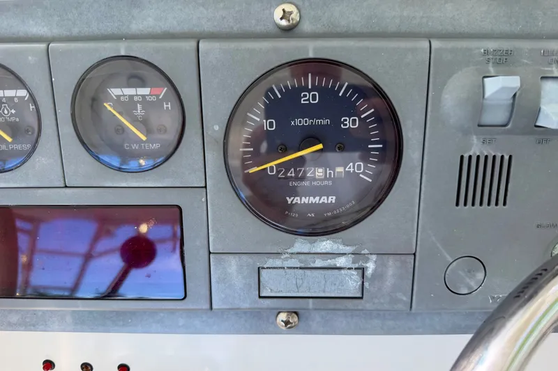 Slide: The Image of Dashboard of a 2001 Henriques 35 Express boat showing engine gauges and controls. - 21