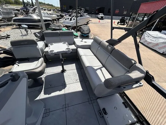 Slide: The Image of The image shows the spacious deck of a 2022 Sea-Doo Switch Sport 18 with gray seating. - 12