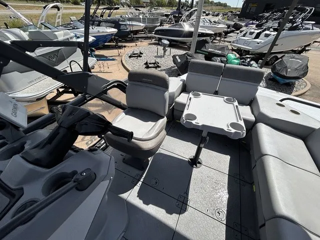 Slide: The Image of The image shows the cockpit of a 2022 Sea-Doo Switch Sport 18 with gray seating and a table. - 13