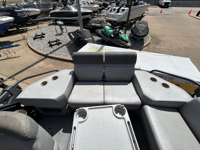 Slide: The Image of The image shows the gray seating area of a 2022 Sea-Doo Switch Sport 18, surrounded by other boats. - 14