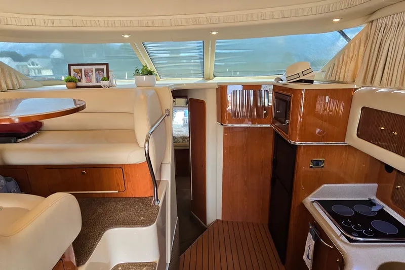 Slide: The Image of Interior of 2000 Sea Ray 400 Sedan Bridge yacht with elegant seating and kitchen area. - 27