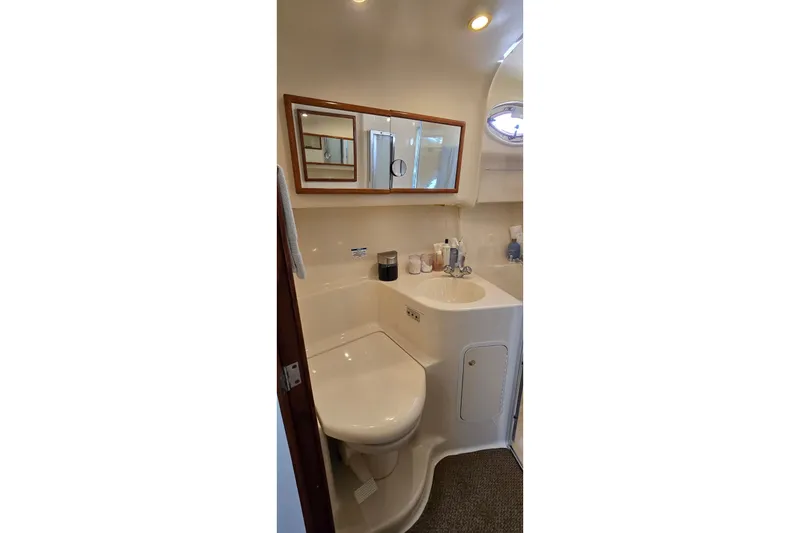 Slide: The Image of Bathroom interior of 2000 Sea Ray 400 Sedan Bridge yacht, featuring sink and mirror. - 38