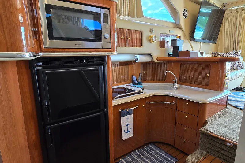 Slide: The Image of Luxurious 2000 Sea Ray 400 Sedan Bridge yacht interior with modern kitchen amenities. - 40