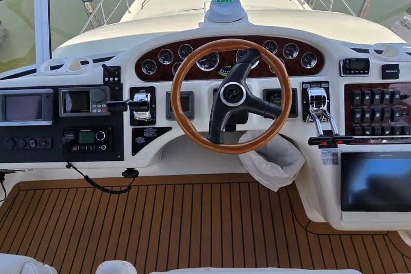 Slide: The Image of Cockpit of 2000 Sea Ray 400 Sedan Bridge with steering wheel and navigation controls. - 9