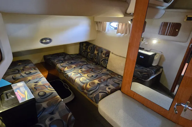Slide: The Image of Interior cabin of a 2000 Sea Ray 400 Sedan Bridge with patterned seating and storage. - 32