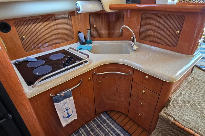 Slide: The Image of Luxurious kitchen area in a 2000 Sea Ray 400 Sedan Bridge yacht. - 28