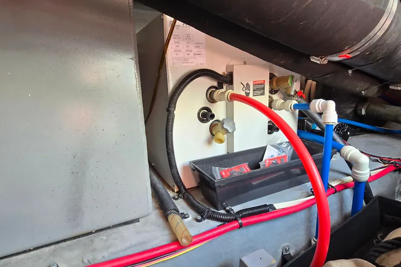 Slide: The Image of Engine room of 2000 Sea Ray 400 Sedan Bridge with visible hoses and wiring. - 45