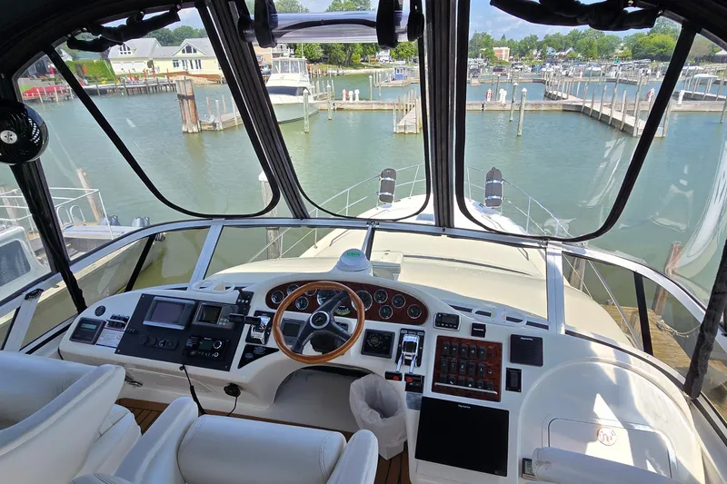 Slide: The Image of Cockpit view of 2000 Sea Ray 400 Sedan Bridge yacht at marina. - 8