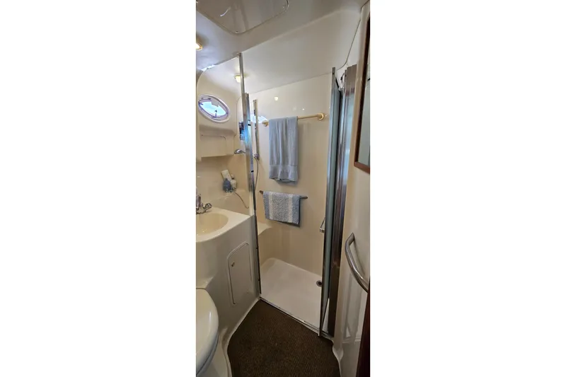 Slide: The Image of Bathroom interior of 2000 Sea Ray 400 Sedan Bridge yacht, featuring shower and sink. - 39