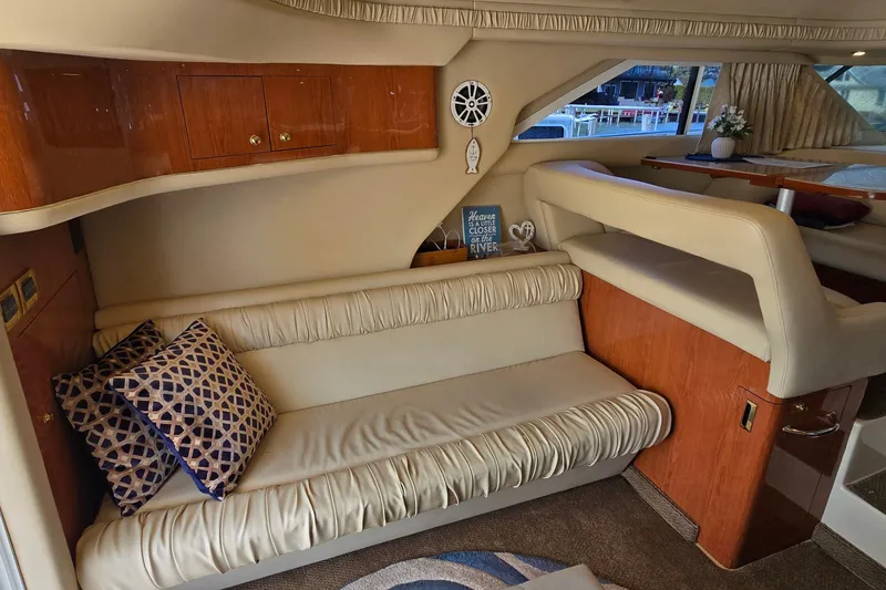 Slide: The Image of Luxurious interior of 2000 Sea Ray 400 Sedan Bridge with plush seating and elegant decor. - 23