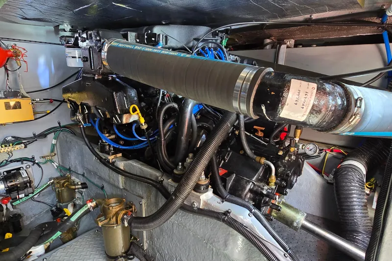 Slide: The Image of Engine room of a 2000 Sea Ray 400 Sedan Bridge, showcasing mechanical components and wiring. - 48