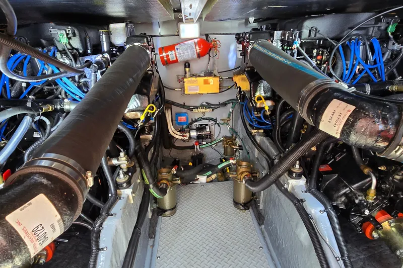 Slide: The Image of Engine room of a 2000 Sea Ray 400 Sedan Bridge with visible components and wiring. - 47