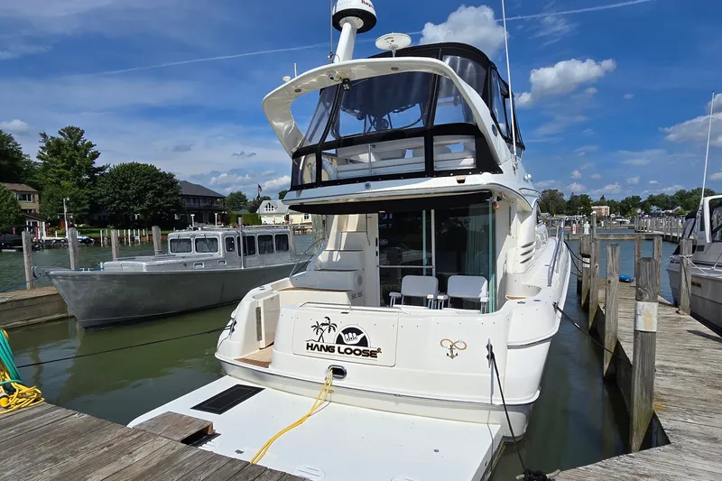 Slide: The Image of 2000 Sea Ray 400 Sedan Bridge docked at marina under clear blue sky. - 3