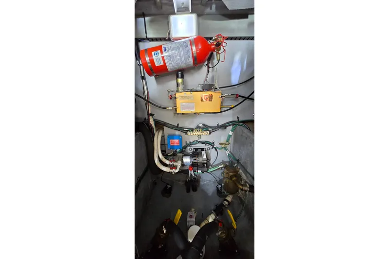 Slide: The Image of Engine room of 2000 Sea Ray 400 Sedan Bridge with fire extinguisher and mechanical components. - 50