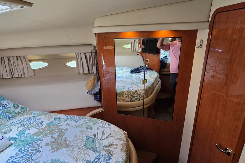 Slide: The Image of Interior cabin of 2000 Sea Ray 400 Sedan Bridge with mirrored closet and nautical decor. - 37