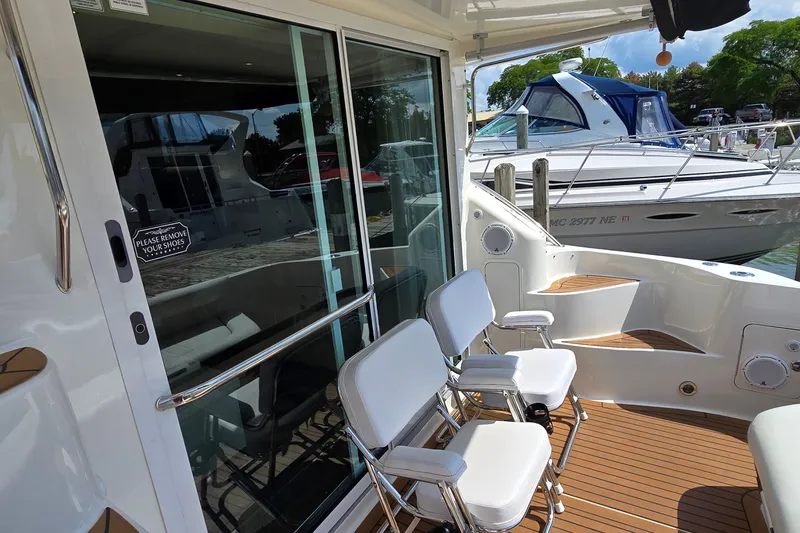 Slide: The Image of 2000 Sea Ray 400 Sedan Bridge yacht with outdoor seating and sliding glass door. - 19